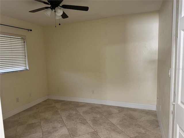 unfurnished room with baseboards, a ceiling fan, and light tile patterned flooring