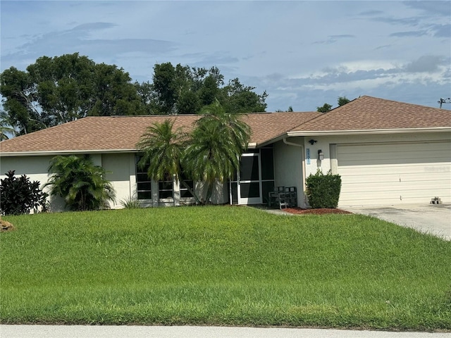 single story home featuring concrete driveway, a front lawn, an attached garage, and stucco siding