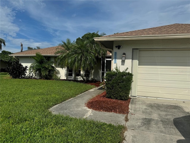 view of front of house featuring a garage and a front yard