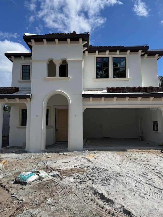 view of front of home with stucco siding and a garage