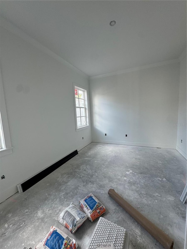 unfurnished room with crown molding