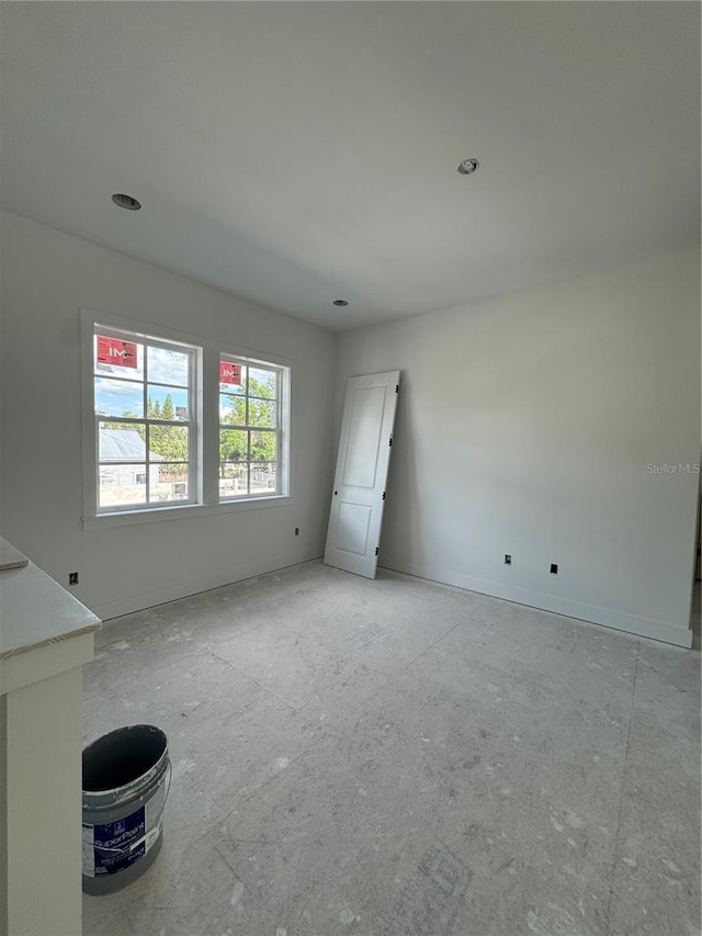 spare room featuring baseboards