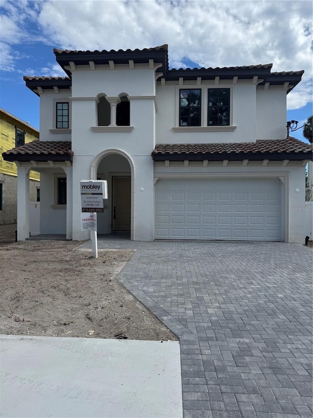 320 W Park Ave, Tampa, FL 33602 - view of front of property with a tiled roof, decorative driveway, a garage, and stucco siding