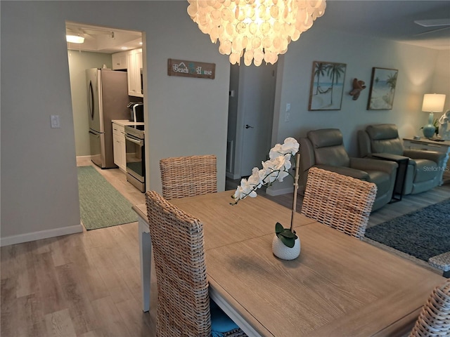 dining room featuring light hardwood / wood-style flooring and a chandelier