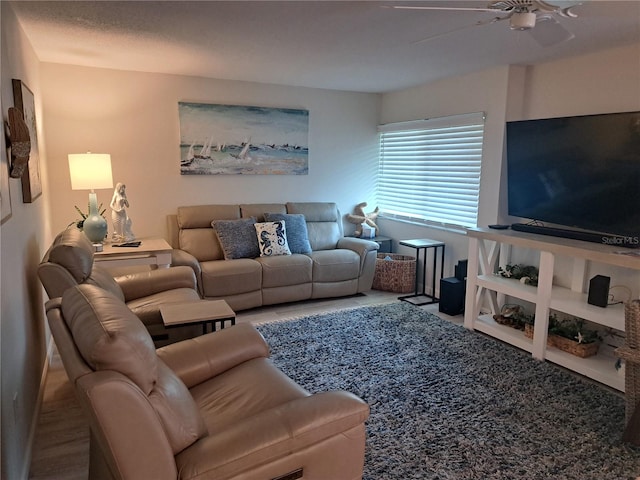 carpeted living room with ceiling fan