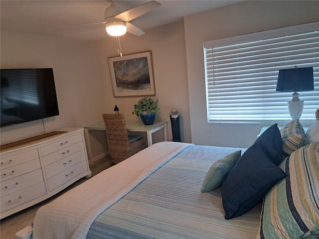 bedroom with ceiling fan and wood-type flooring