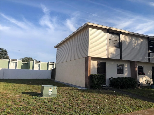 view of property exterior with a yard