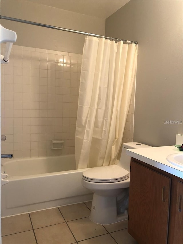 full bathroom featuring tile patterned flooring, shower / bath combo, toilet, and vanity