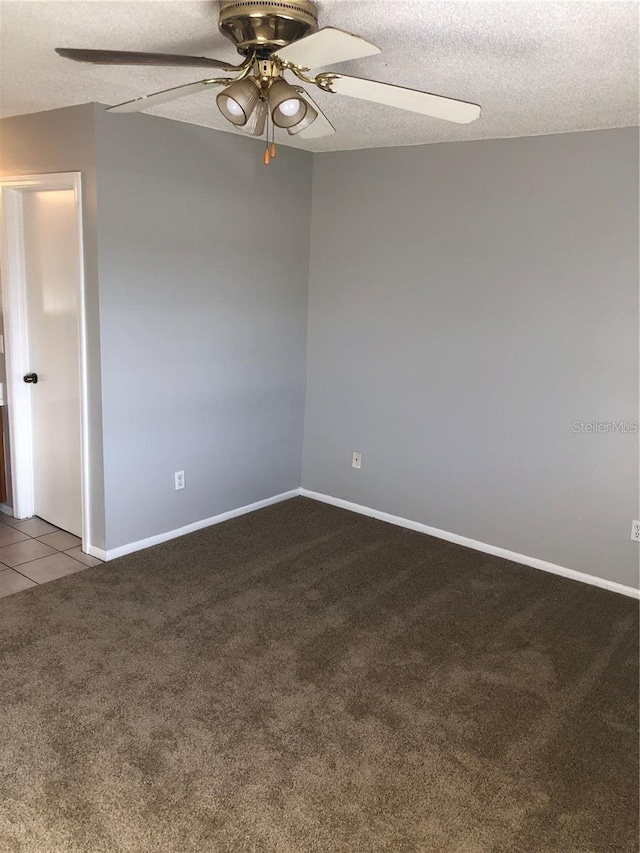 unfurnished room featuring ceiling fan, light carpet, and a textured ceiling