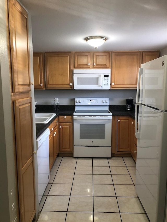 kitchen featuring sink, white appliances, and light tile patterned floors