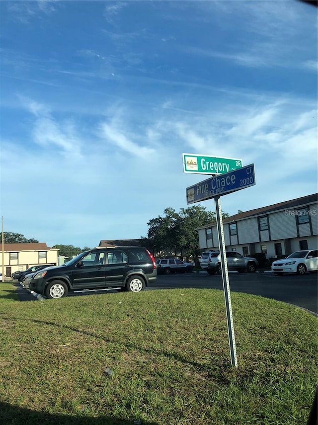 view of parking featuring a yard