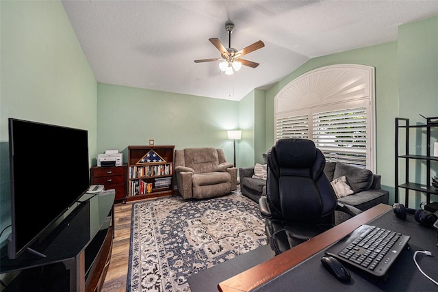 office featuring hardwood / wood-style floors, ceiling fan, lofted ceiling, and a textured ceiling