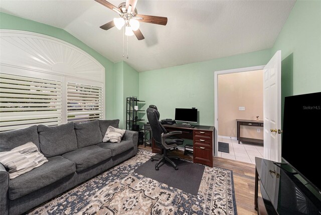 office space featuring lofted ceiling, ceiling fan, and light wood-type flooring