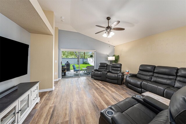 living room featuring hardwood / wood-style floors, ceiling fan, and lofted ceiling