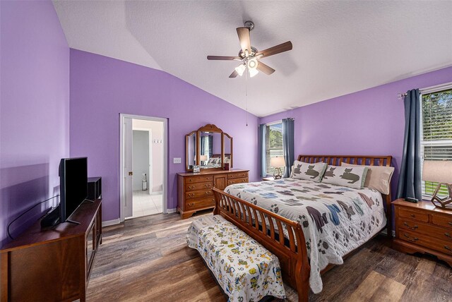 bedroom with multiple windows, ceiling fan, dark hardwood / wood-style floors, and lofted ceiling