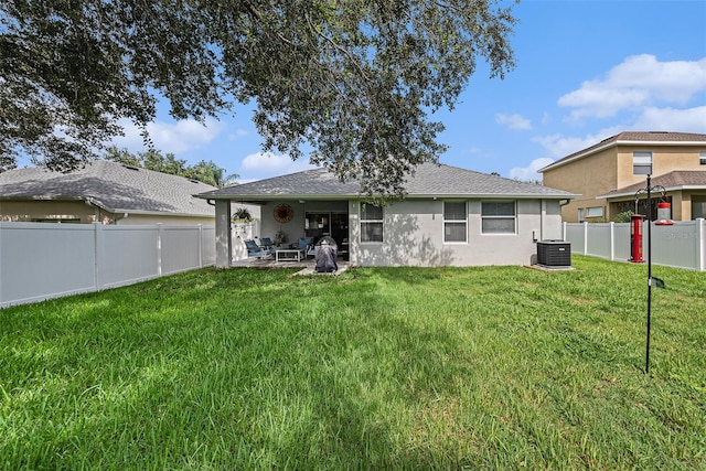 back of property featuring a yard, a patio, and central air condition unit