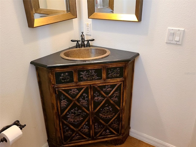 bathroom with vanity and baseboards