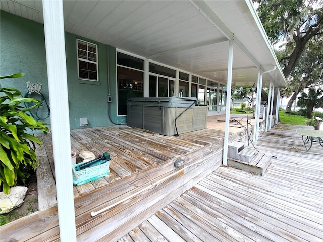 wooden deck with a hot tub