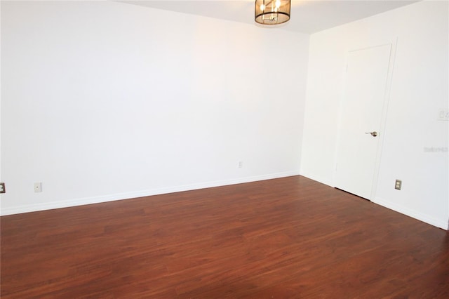 empty room with dark hardwood / wood-style floors