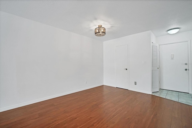 spare room with wood-type flooring and a textured ceiling