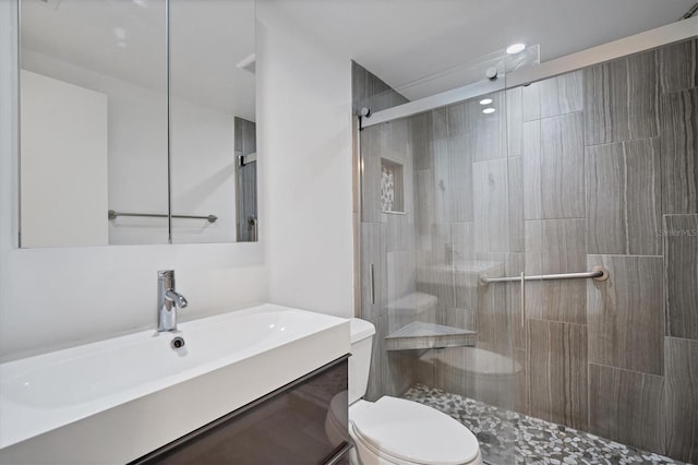 bathroom with vanity, toilet, and walk in shower