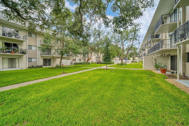 view of property's community featuring a yard