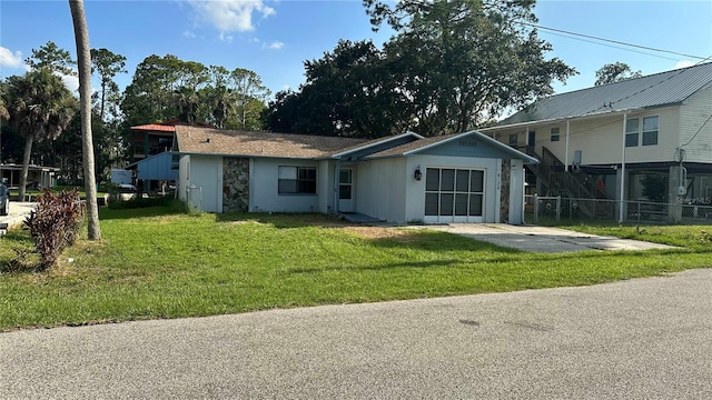 view of front of home featuring a garage and a front yard