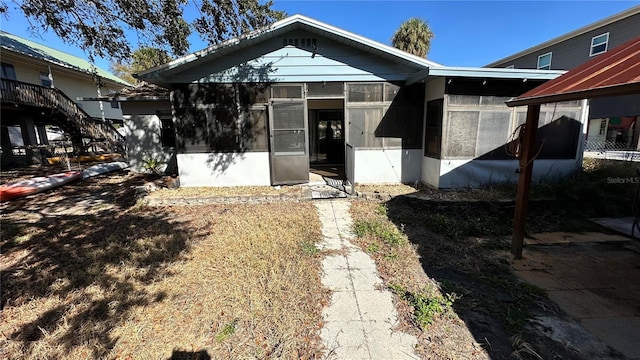 view of front of house with a sunroom