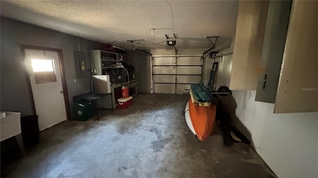 garage with a garage door opener and electric panel