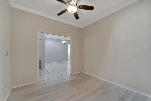 empty room with crown molding, light hardwood / wood-style floors, and ceiling fan with notable chandelier