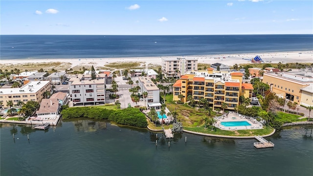 drone / aerial view featuring a beach view and a water view