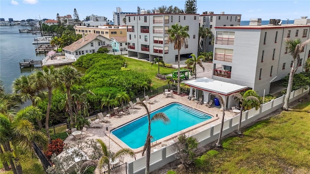 view of pool featuring a patio and a water view