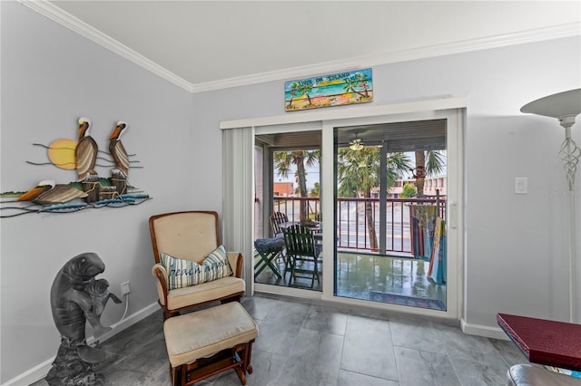 sitting room with ceiling fan and crown molding