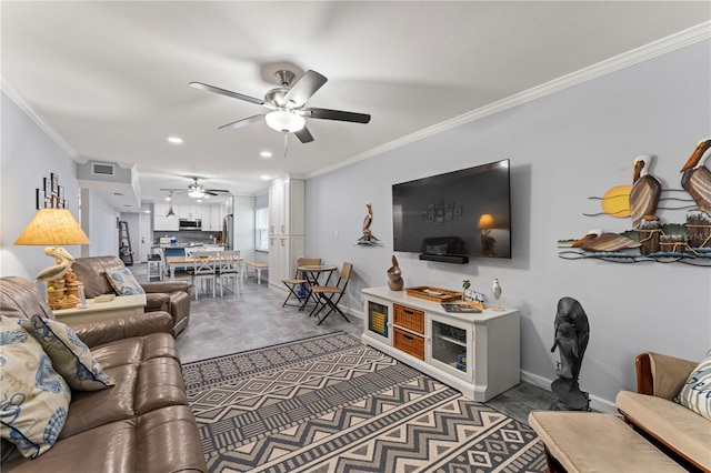 living room with ceiling fan and ornamental molding