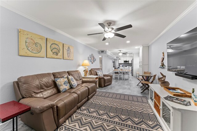 living room with ceiling fan and ornamental molding