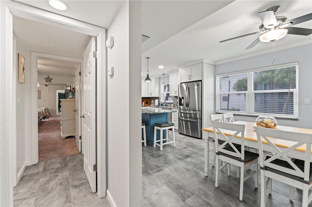 dining area with a textured ceiling, ceiling fan, and light tile patterned floors