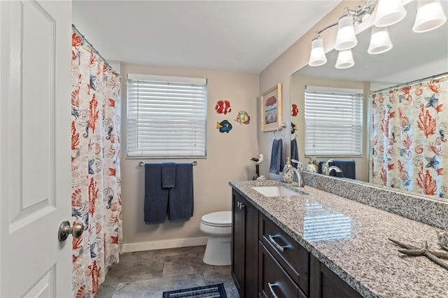 bathroom featuring tile patterned flooring, toilet, vanity, and curtained shower