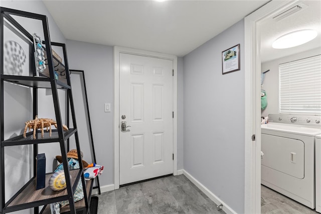 interior space featuring washer / clothes dryer and light tile patterned floors