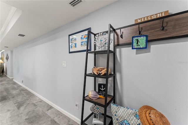 corridor featuring crown molding and light tile patterned floors