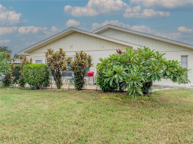 view of side of home featuring a lawn