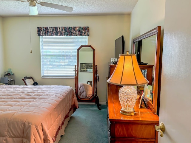 carpeted bedroom with a textured ceiling and ceiling fan