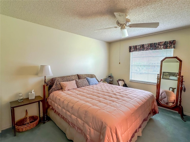 bedroom featuring ceiling fan, carpet flooring, and a textured ceiling