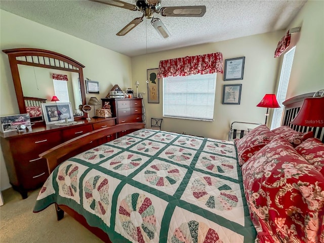 bedroom with carpet, a textured ceiling, and ceiling fan