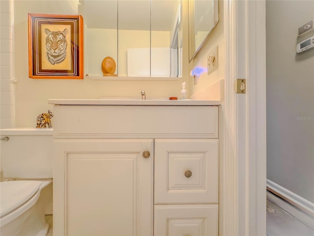 bathroom with toilet and vanity