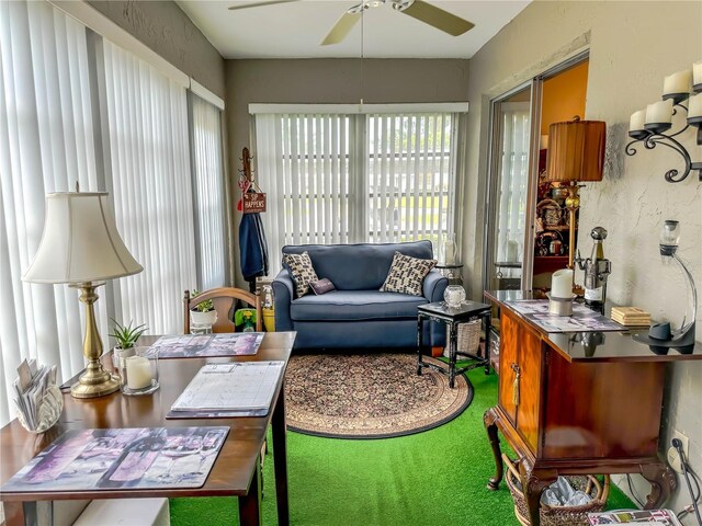 sunroom featuring ceiling fan