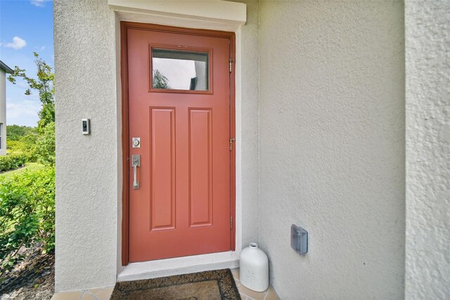 entrance to property with stucco siding