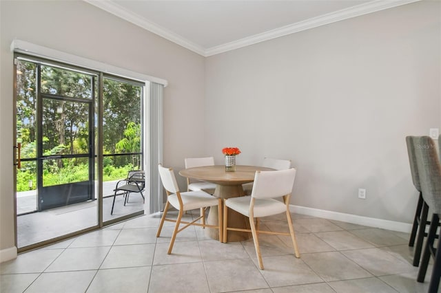 dining area with ornamental molding, light tile patterned flooring, and baseboards