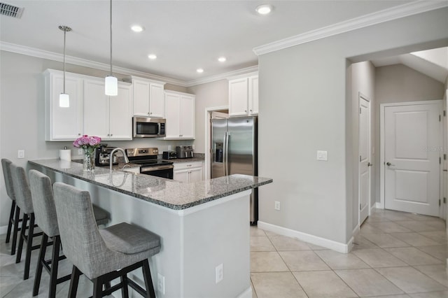 kitchen featuring a peninsula, visible vents, white cabinetry, appliances with stainless steel finishes, and decorative light fixtures