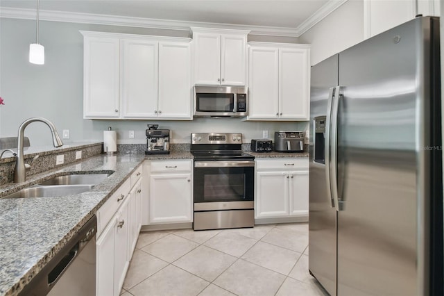 kitchen with stainless steel appliances, white cabinets, a sink, and ornamental molding