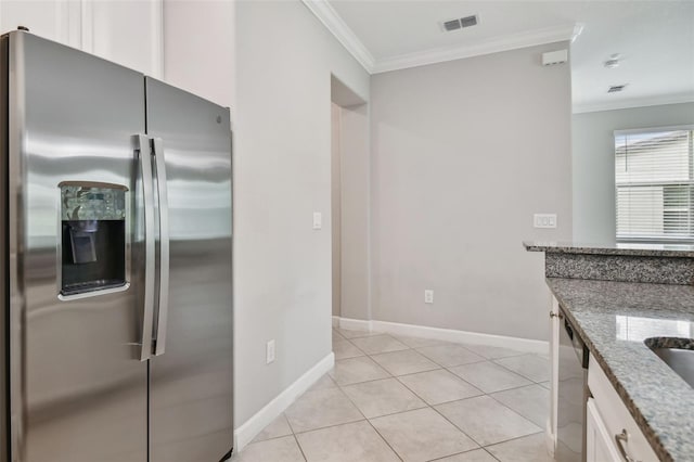 kitchen with light stone counters, visible vents, white cabinets, ornamental molding, and appliances with stainless steel finishes